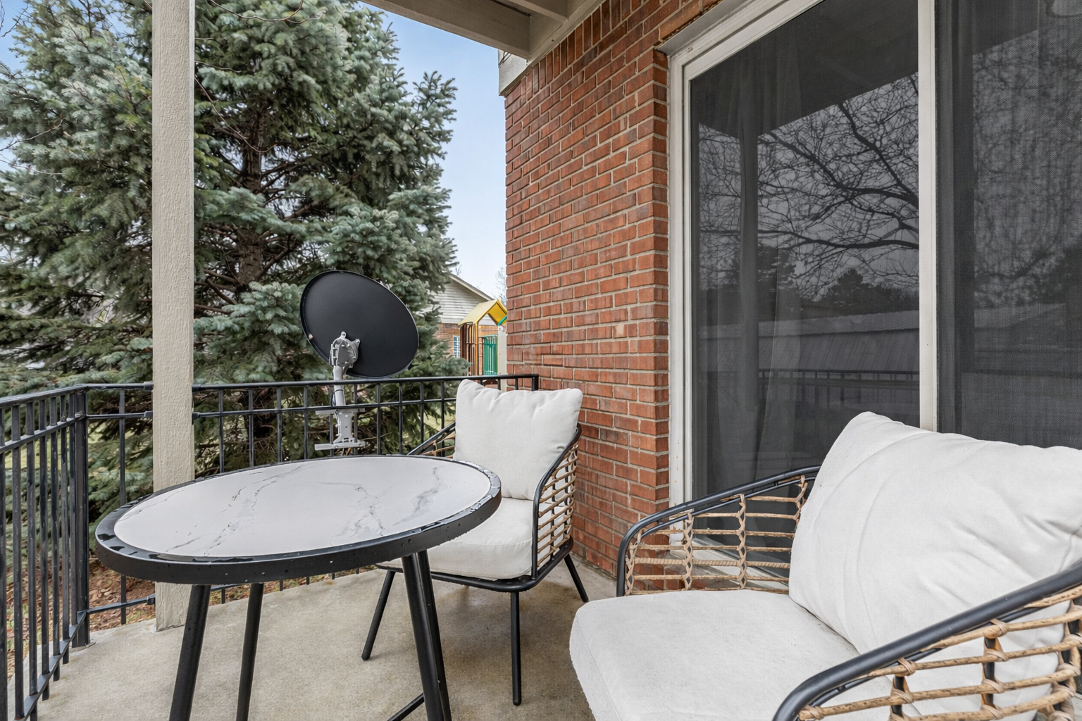 Cozy private patio with comfortable seating, ideal for relaxing outdoors or enjoying a quiet meal.”