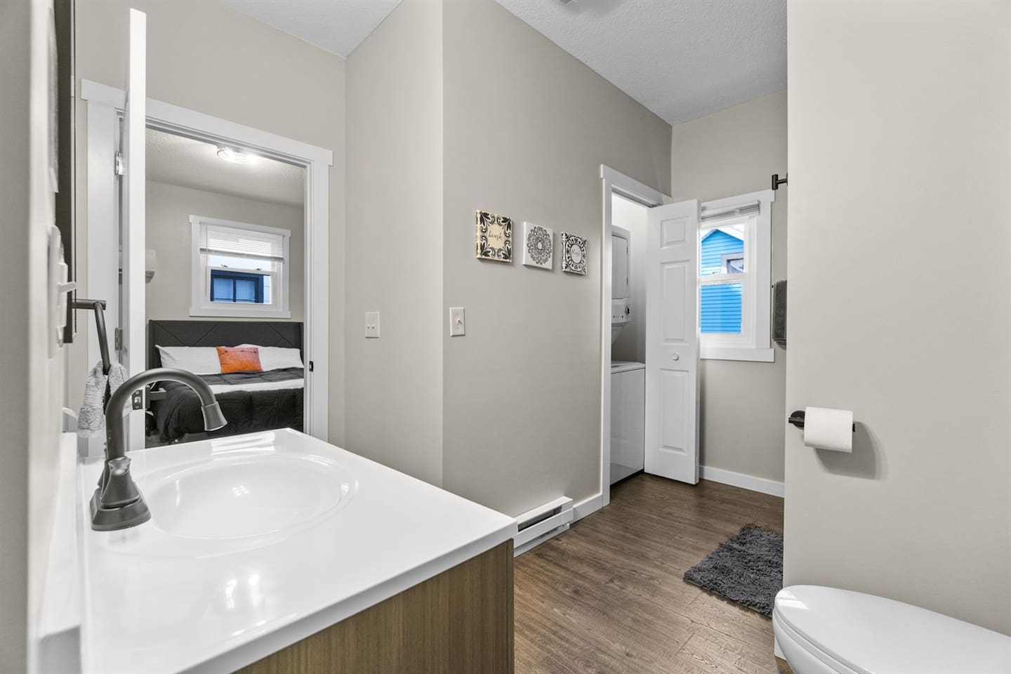 A closet with a washer and dryer tucked in the corner of the bathroom for easy access and efficient use of space.