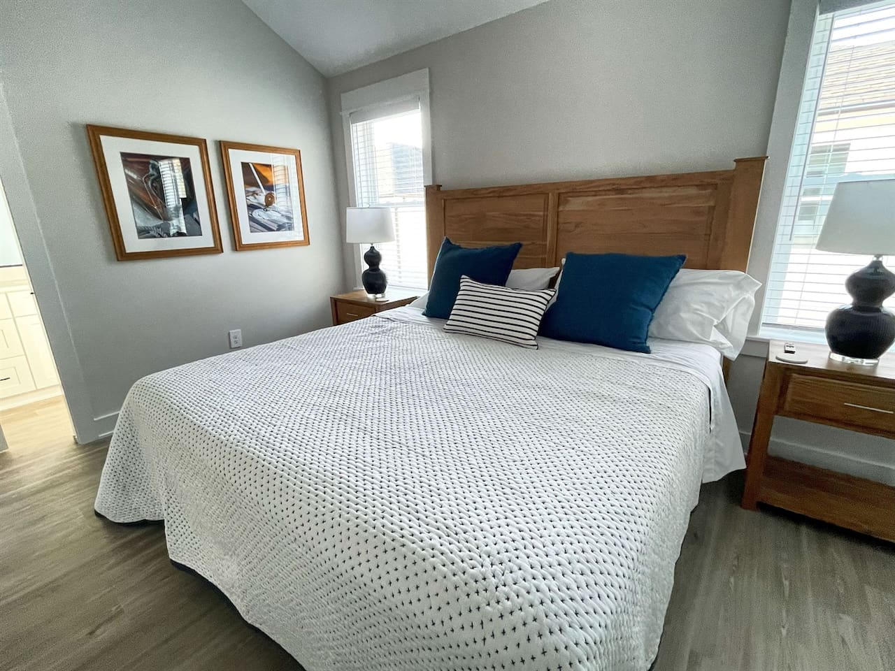 This spacious guest bedroom features a plush king-size bed and cozy coastal décor.