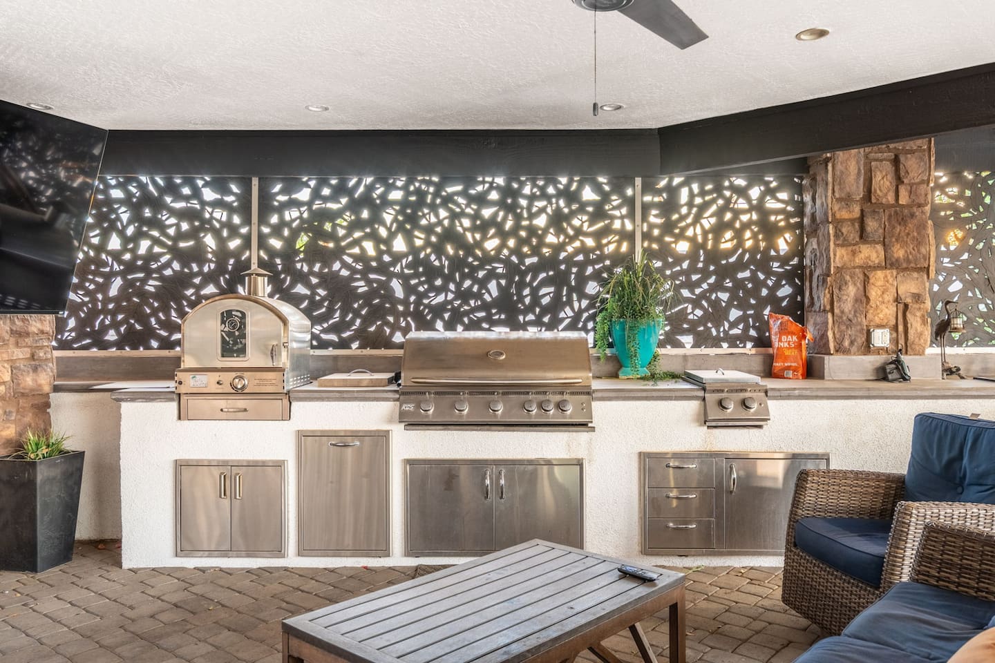 Stainless grills and a built-in pizza oven make this kitchen ready for any feast.