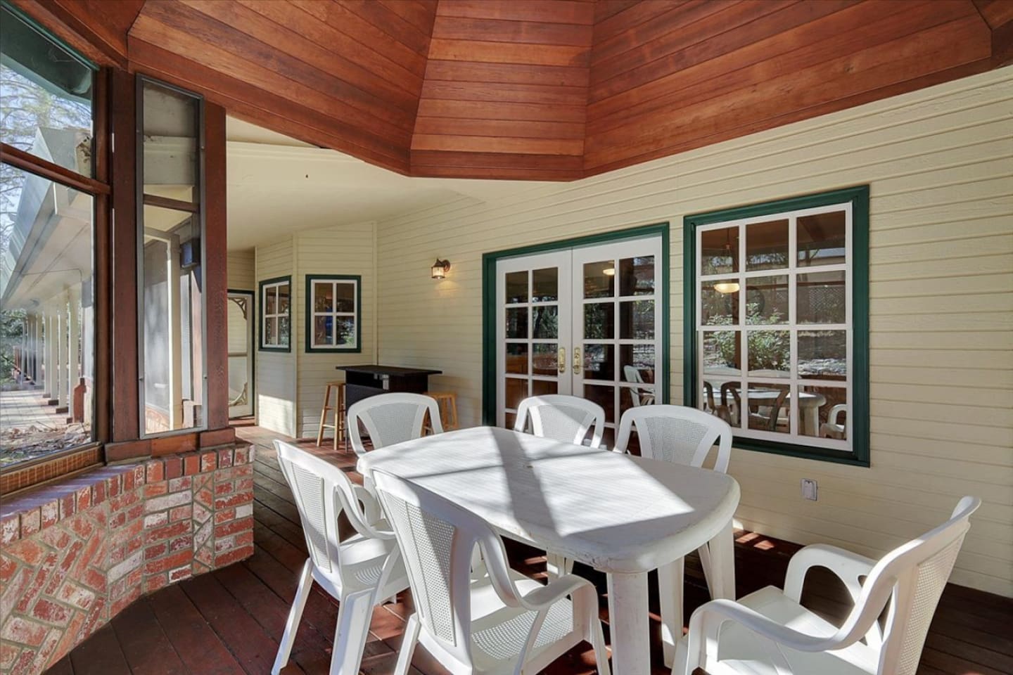 Sunroom with table seating, bar counter, and a peaceful spot to enjoy the view.

