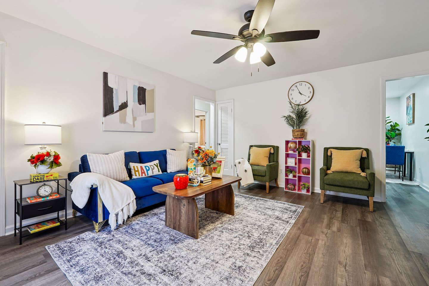The living room features cozy furniture, including a comfortable blue couch, and an Amazon Fire-powered Smart TV for your entertainment. You’ll also find the Xfinity modem conveniently located here, convenient for ethernet connection.