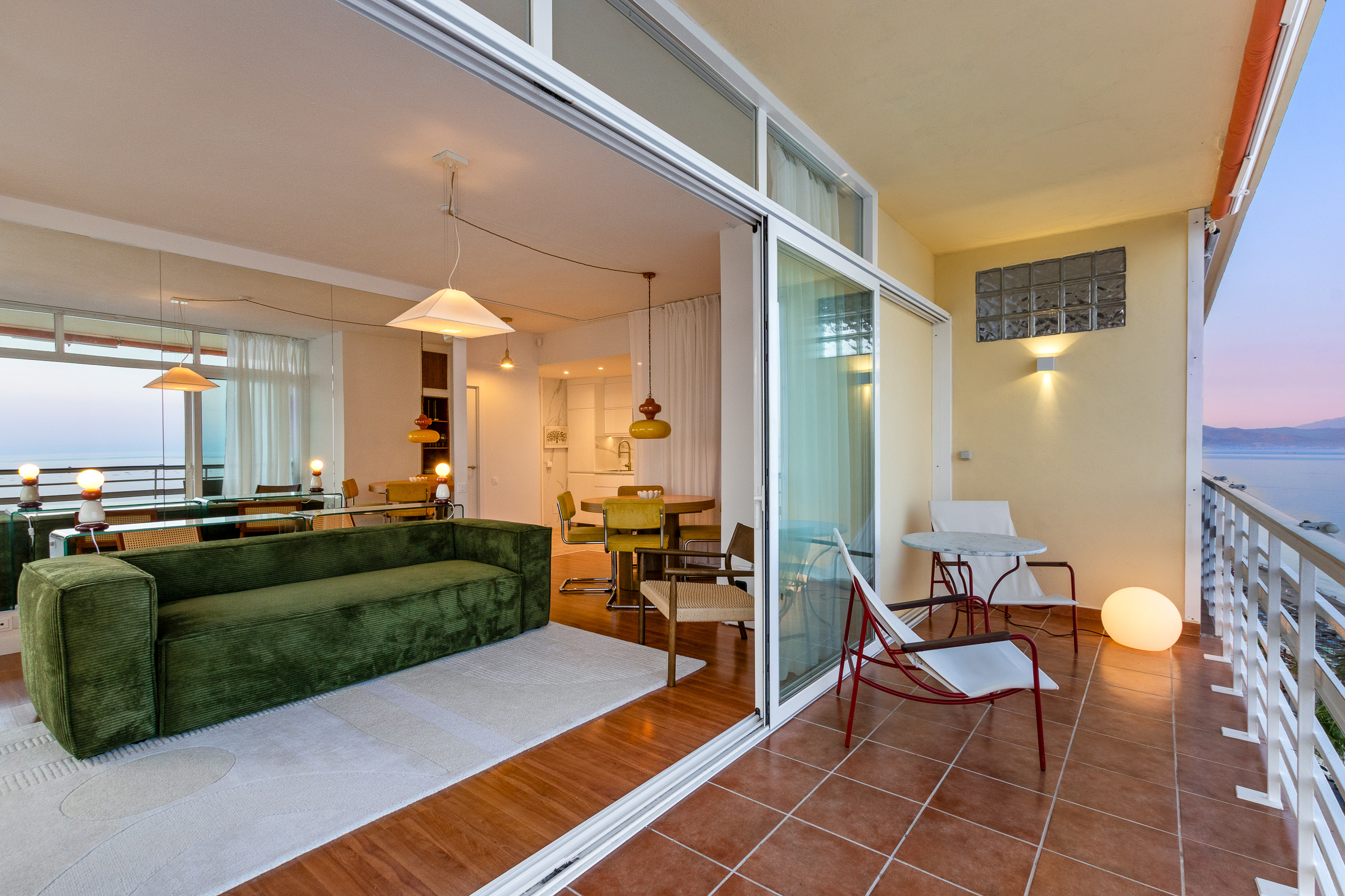 Private balcony with sunset views across the Mediterranean towards the mountains.