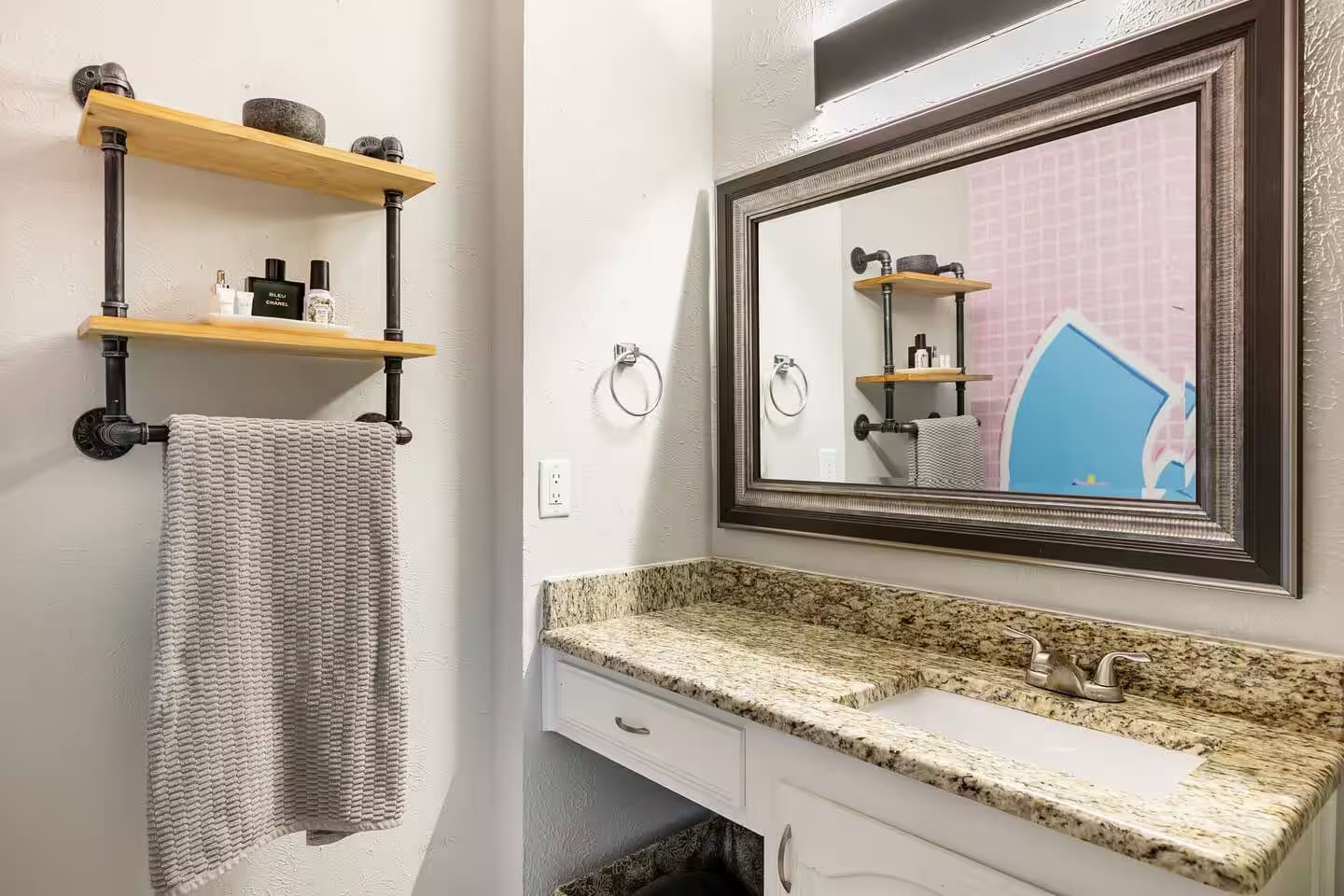 Bathroom with fresh towels and modern shelving.