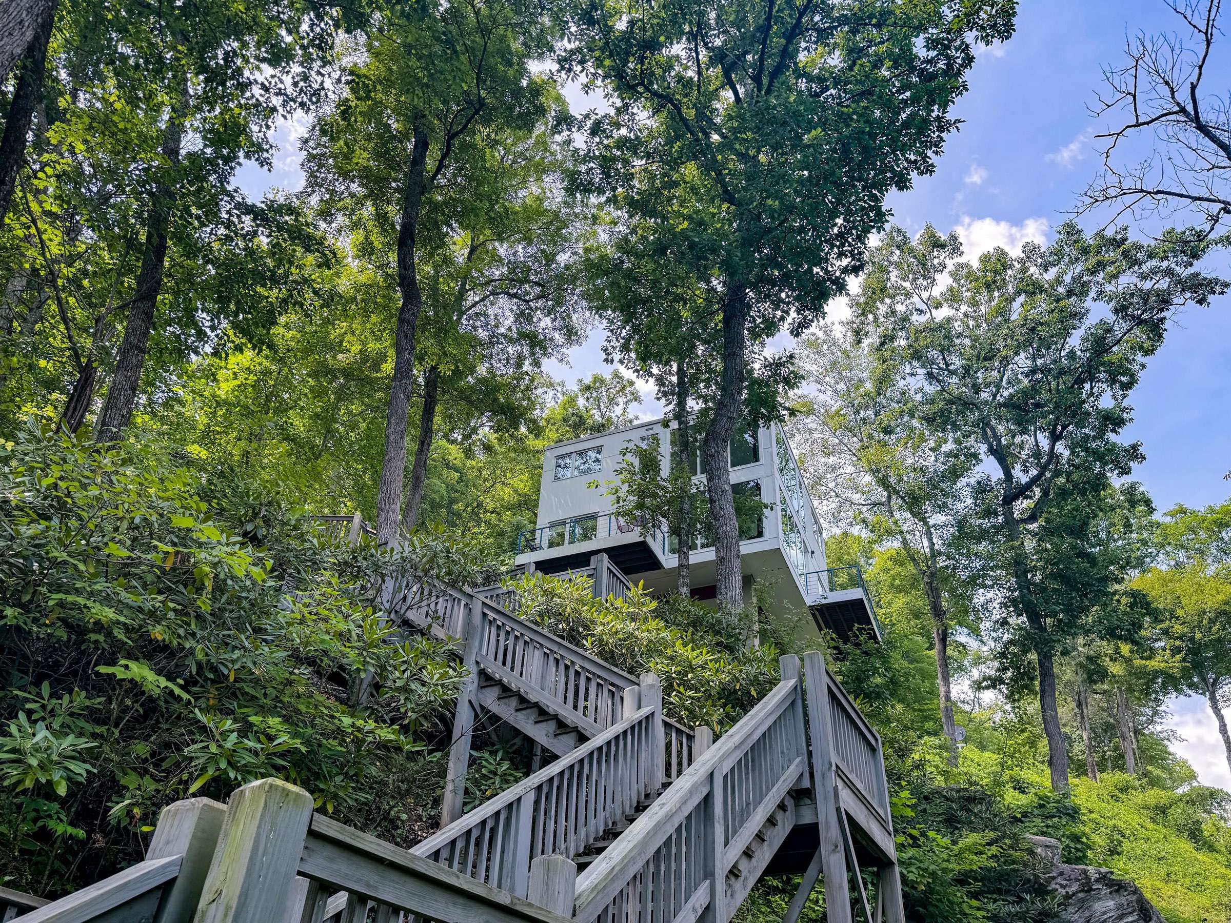 The upper staircase looking up at the house from halfway to the dock! You will love being engulfed in the rhododendron as you make your way along the staircase.