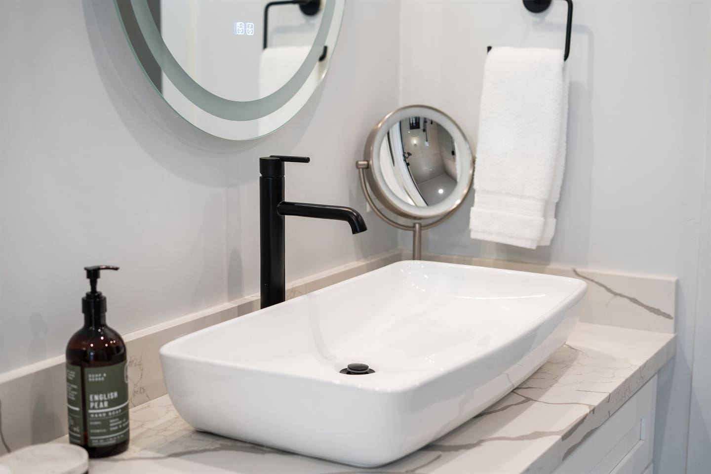 This half bathroom offers a lovely vanity and a toilet, creating a functional space for guests and family alike.