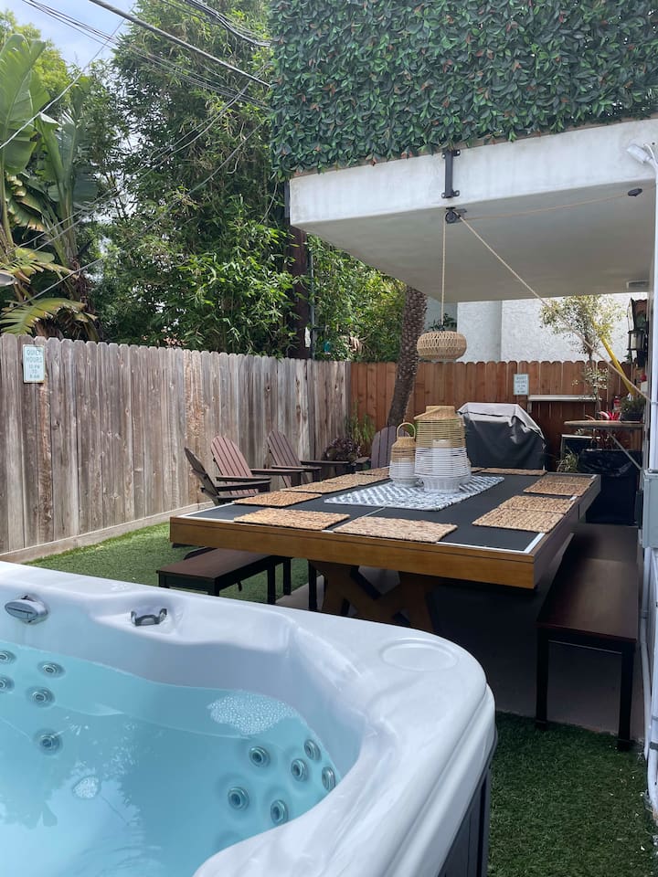 Your own private yard is complete with hot tub, fire pit, drink fridge, music system, plenty of outdoor seating and a TV you can pivot to see from anywhere in the yard.