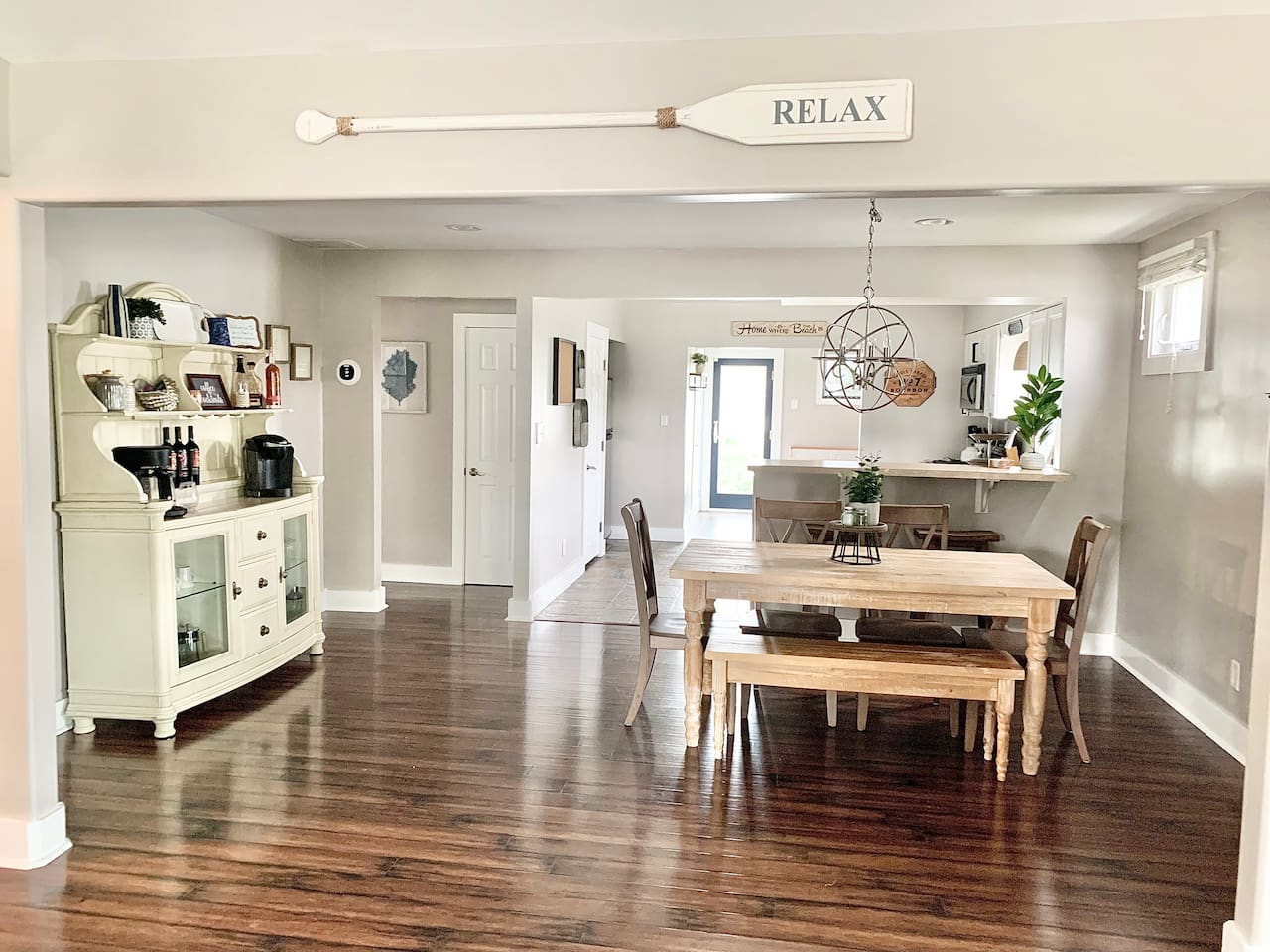 Gather for a meal or a morning coffee in this bright, open dining area. The space features a rustic wooden table with bench seating, a stylish bar area, and a dedicated coffee station to kickstart your vacation mornings.