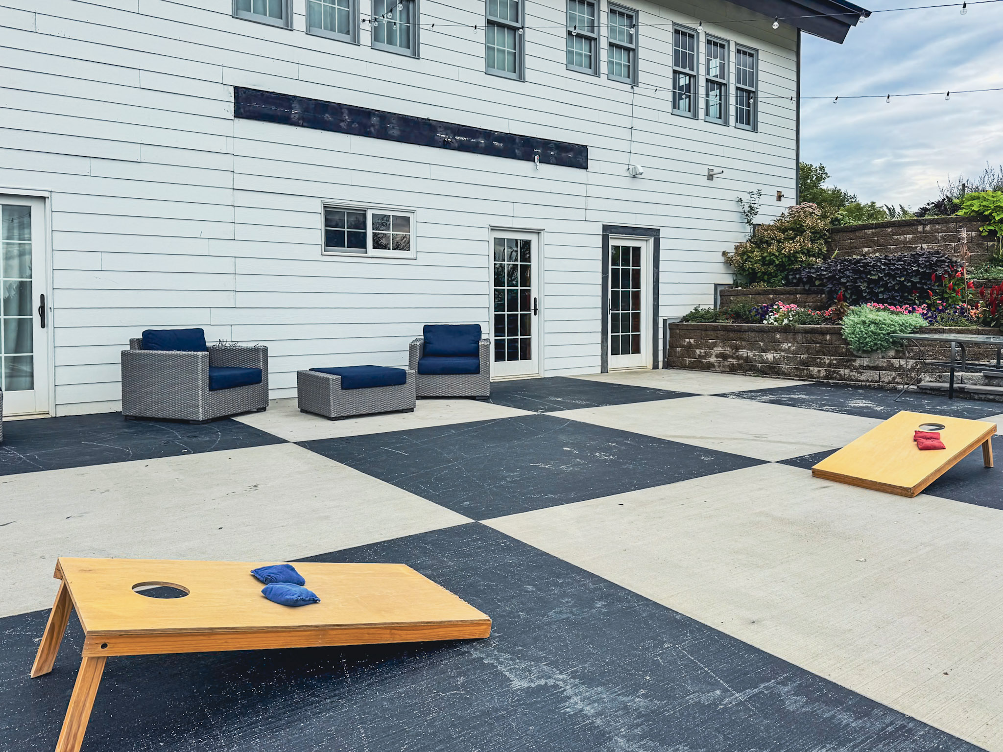 Patio with cornhole and outdoor seating.