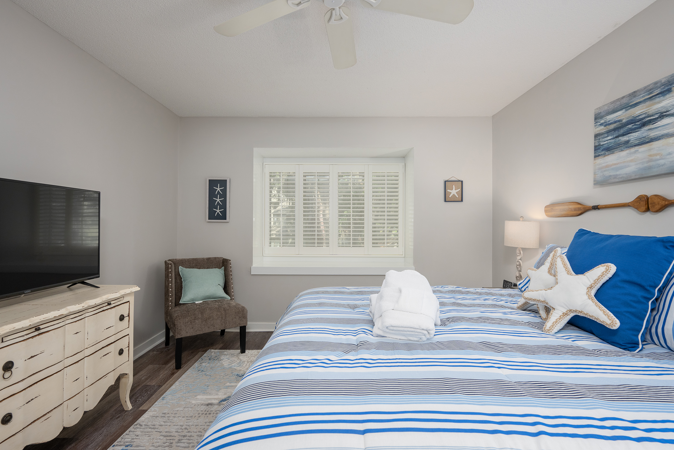 Primary bedroom features a 65" LED HDTV