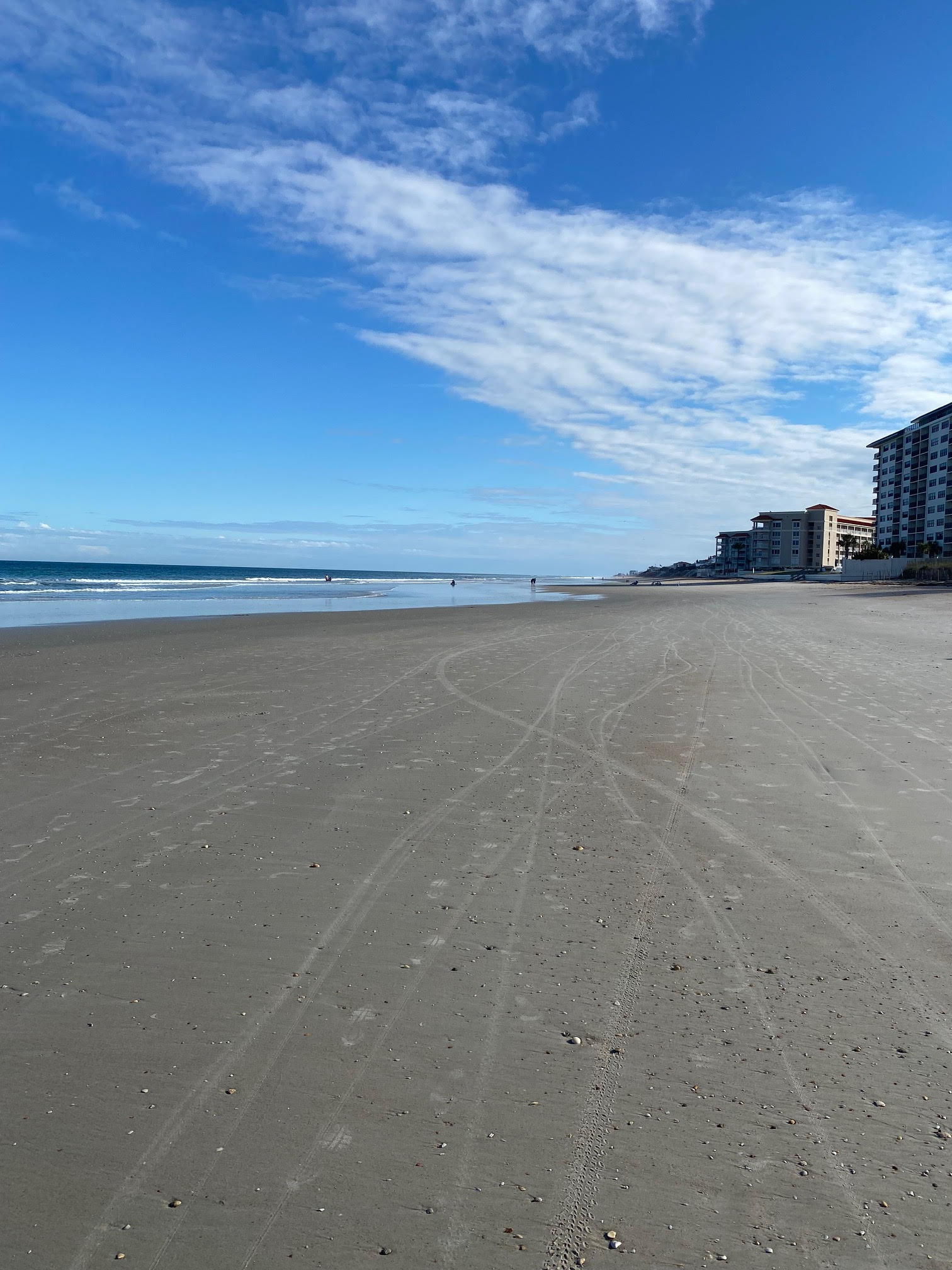 Wide sandy beach with no cars.