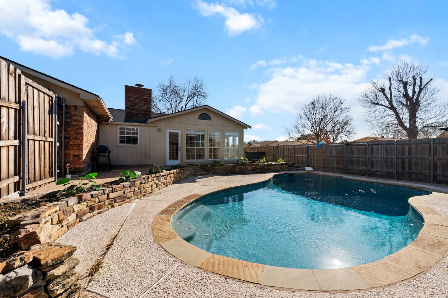 Private backyard oasis with sparkling pool, sun loungers, and direct access to the indoor bar—perfect for poolside entertaining.
