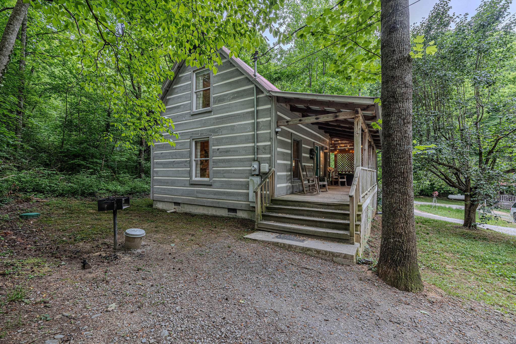 Your own cabin with a grill and trees all around.