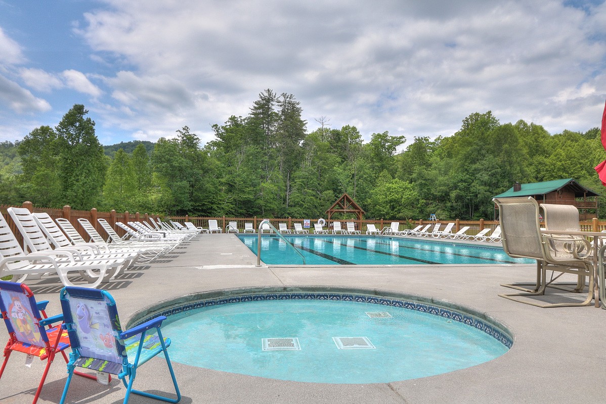 Soak in the hot tub or unwind poolside on comfortable chaise lounges, surrounded by peaceful trees and mountain views.