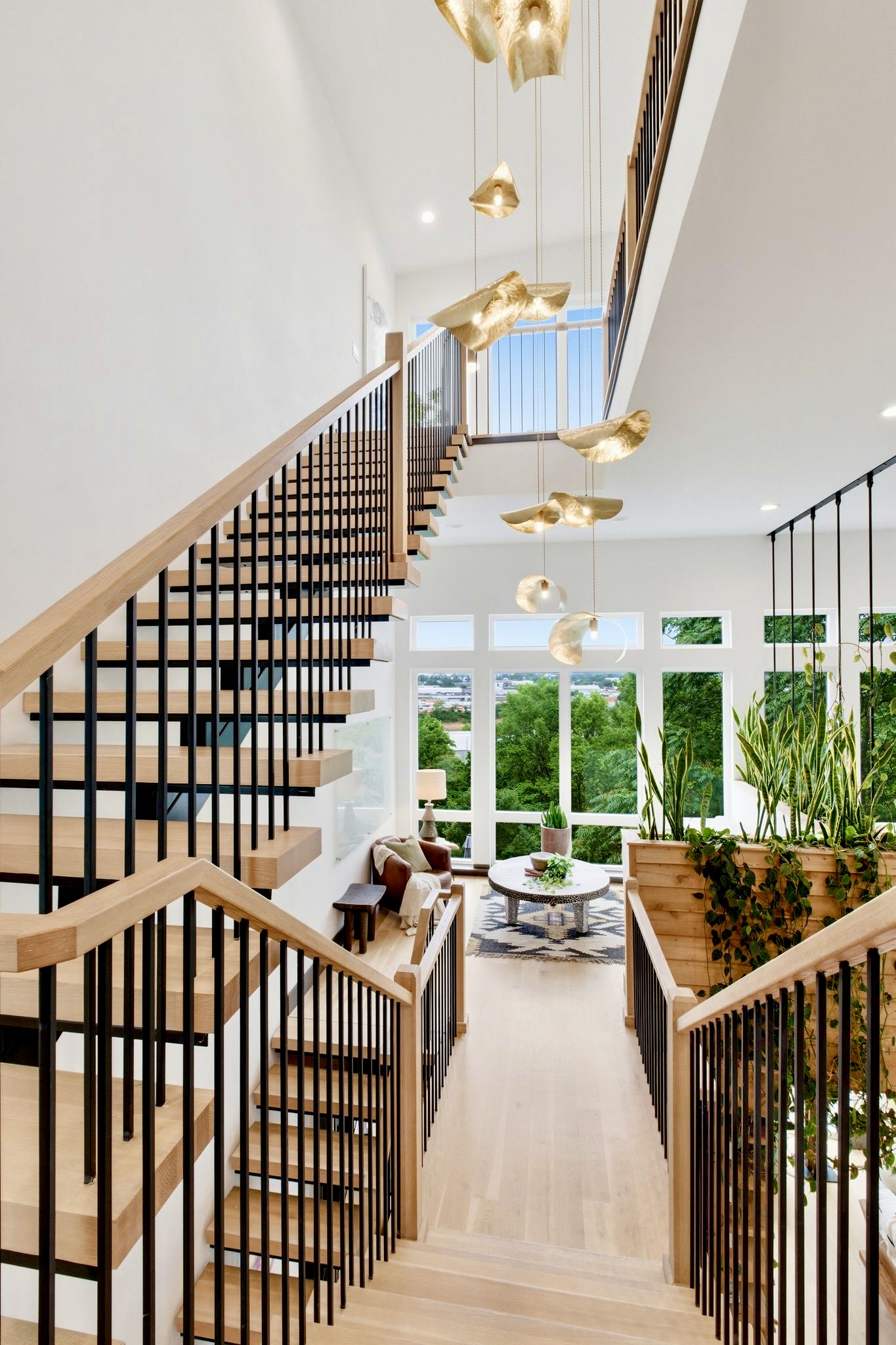 Sleek open staircase w/ wood treads & black railings — sculptural details at every turn.
