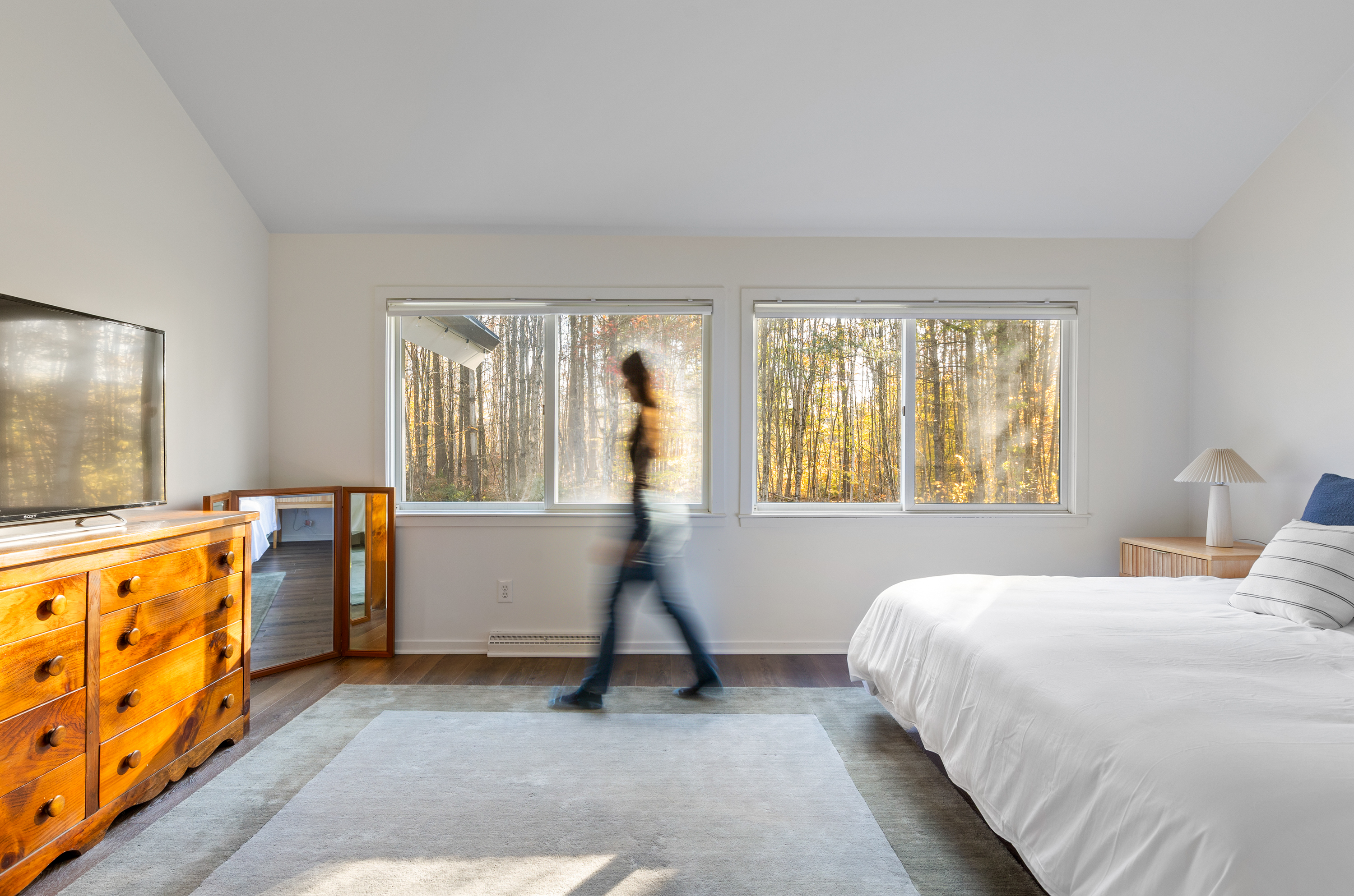 Spacious primary bedroom withforest views