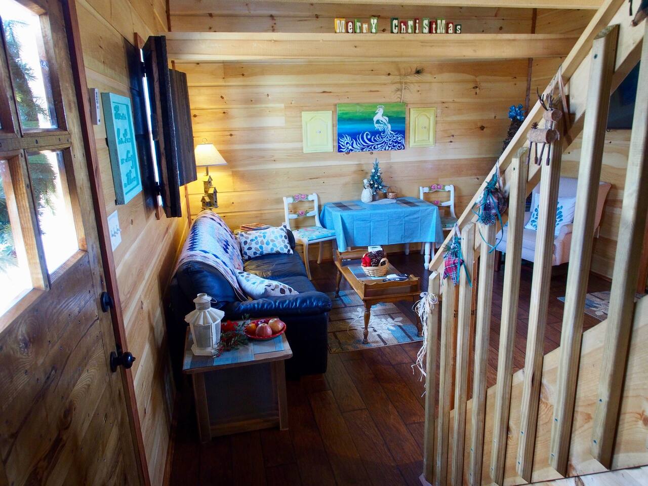 Living Room Area with Stairs to Open Air Loft
