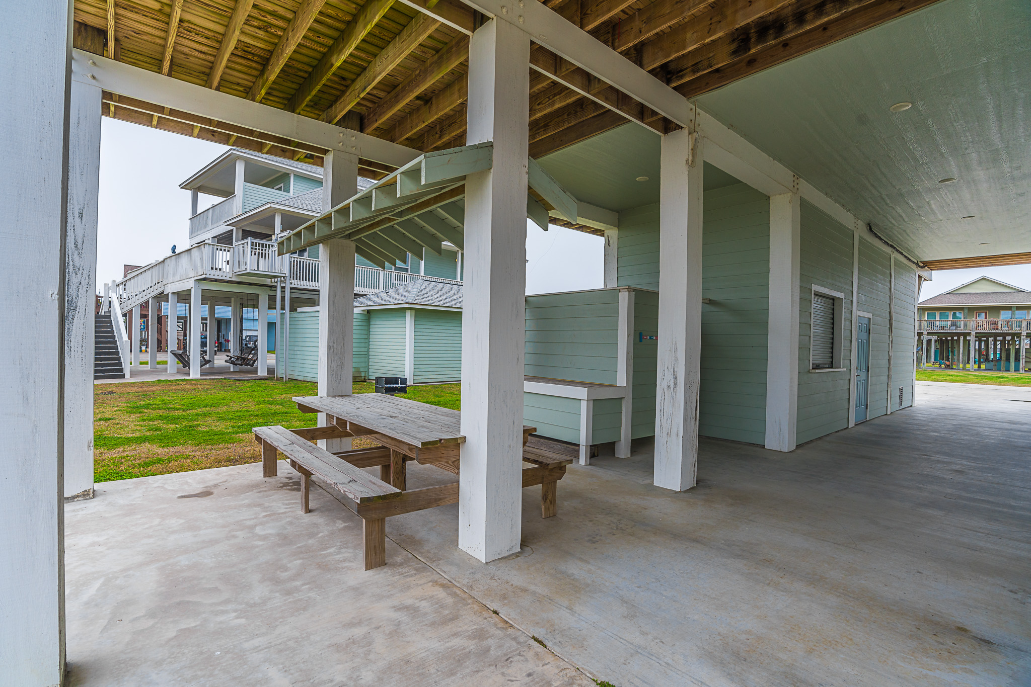 Patio with picnic table seating and enclosed outdoor shower.