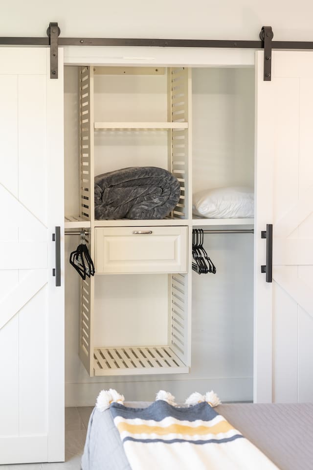 With designated space for hanging garments and folded essentials, this open closet setup keeps things minimal and tidy.

