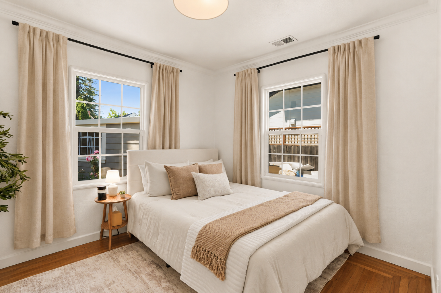 Bedroom 2 offers a cozy queen bed, soft bedding, natural light, and a peaceful atmosphere for a restful night’s sleep.