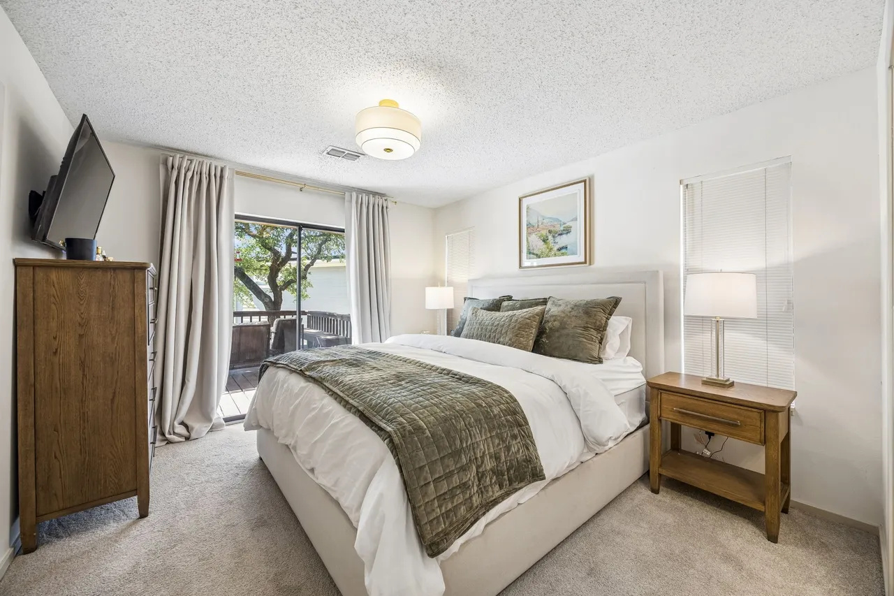 Queen bedroom with television and direct deck access.