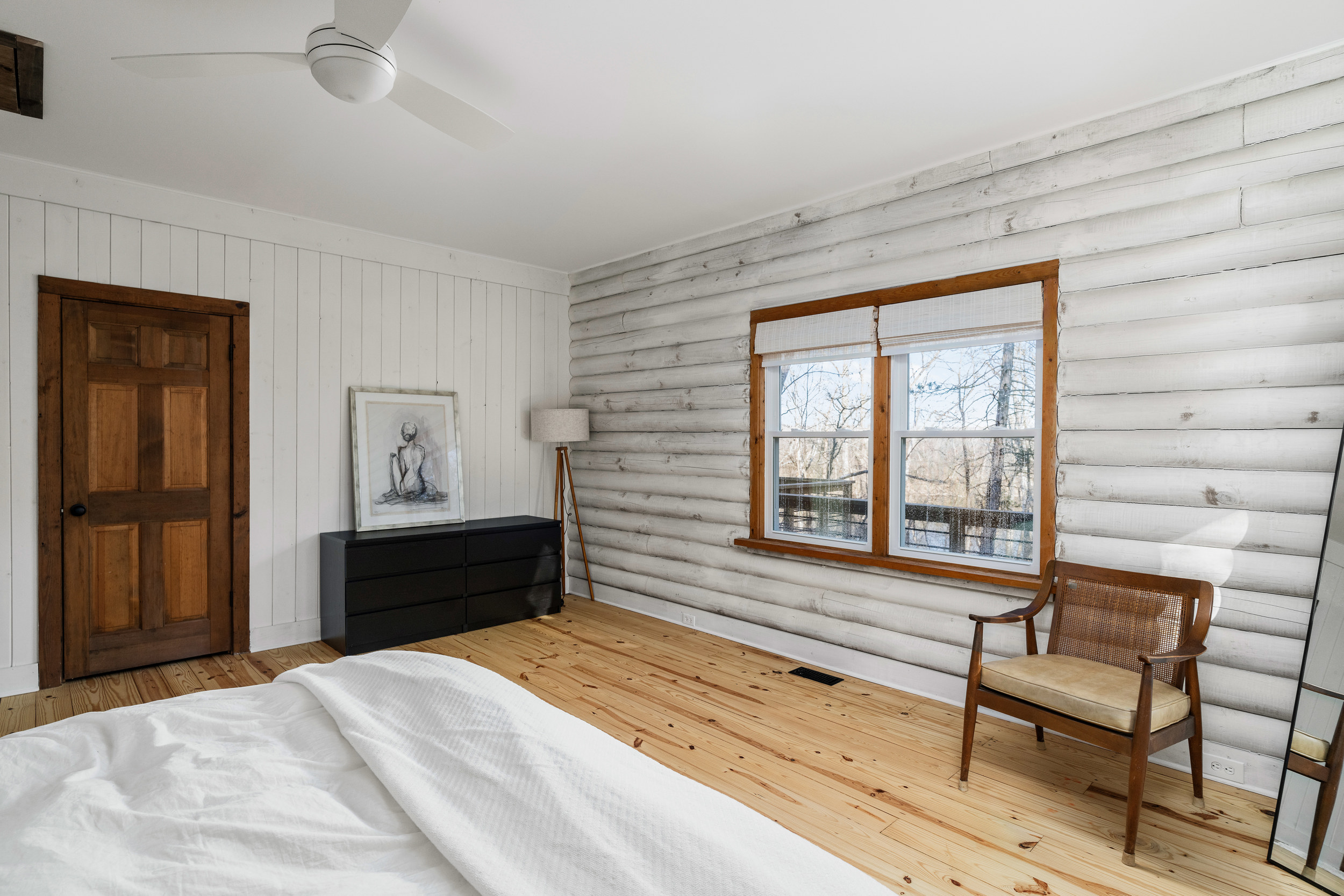 Bedroom 1: Bright and airy retreat with modern decor and picturesque woodland views!
