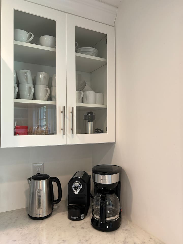 Coffee & tea station with a drip coffee maker and a Nespresso machine. Coffee and tea provided!