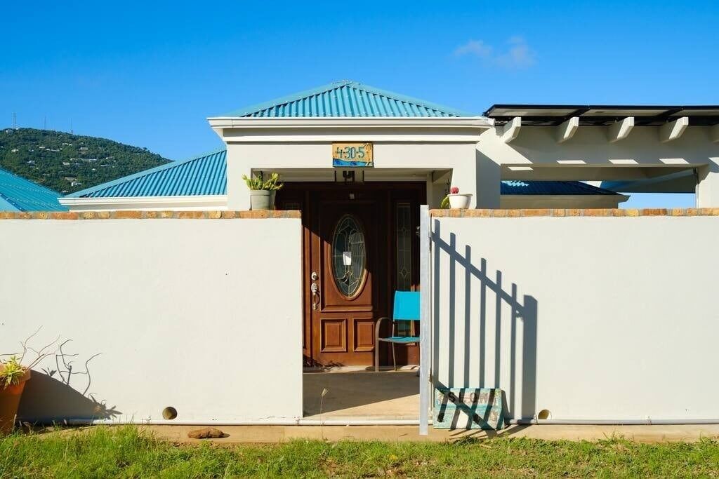 This door is the entrance to the upstairs unit. Enter through the gate and turn left.