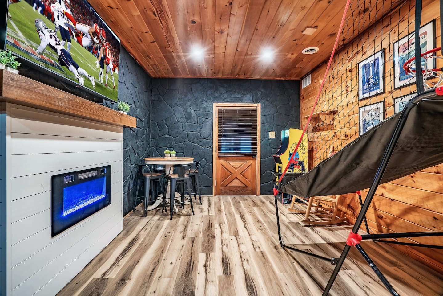 Entertainment-packed mountain cabin game room featuring classic arcade games and a basketball shootout, creating endless fun for family and friends.