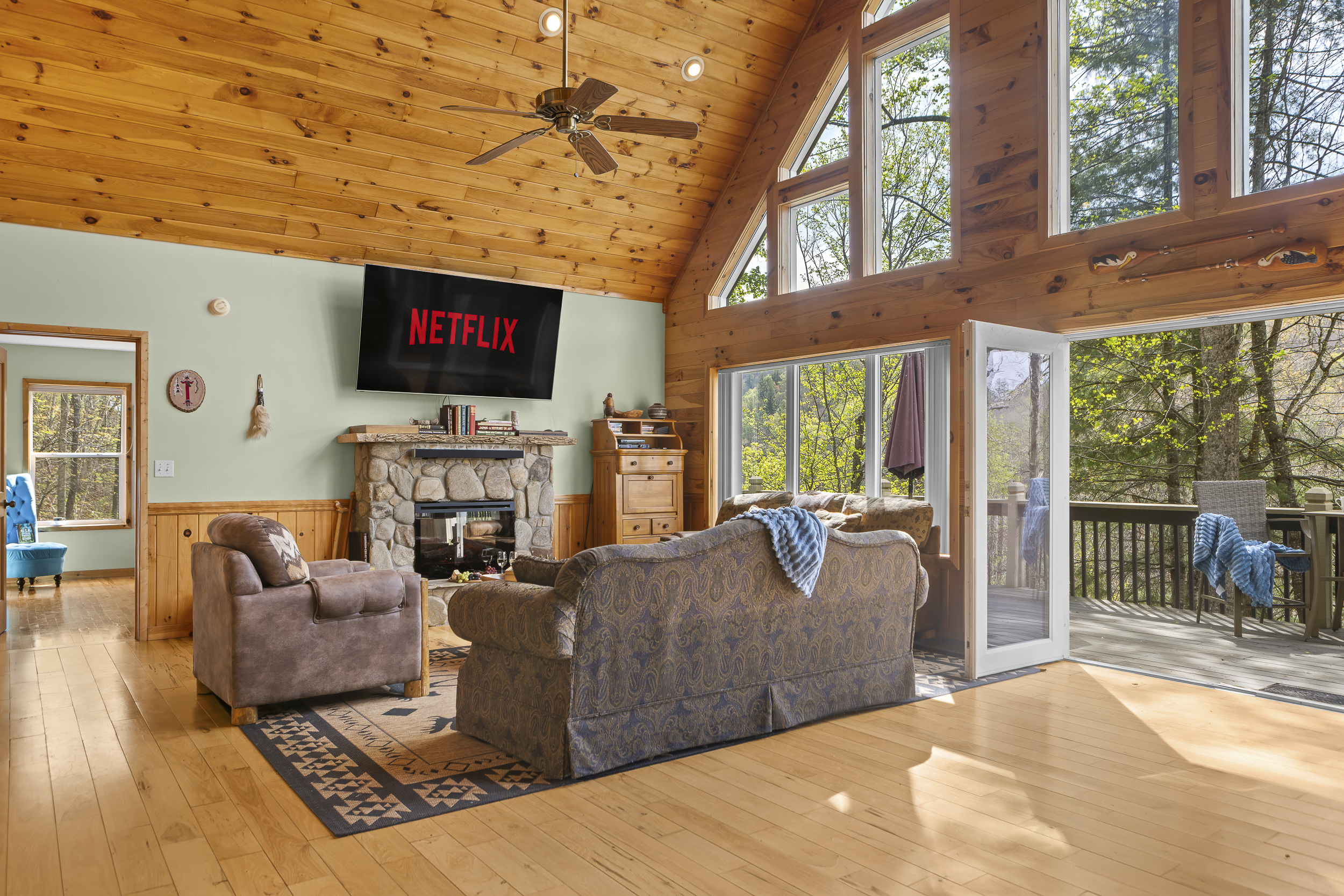 Living Area: Enjoy sunlit views and movie nights in this stylish, nature-inspired gathering space!