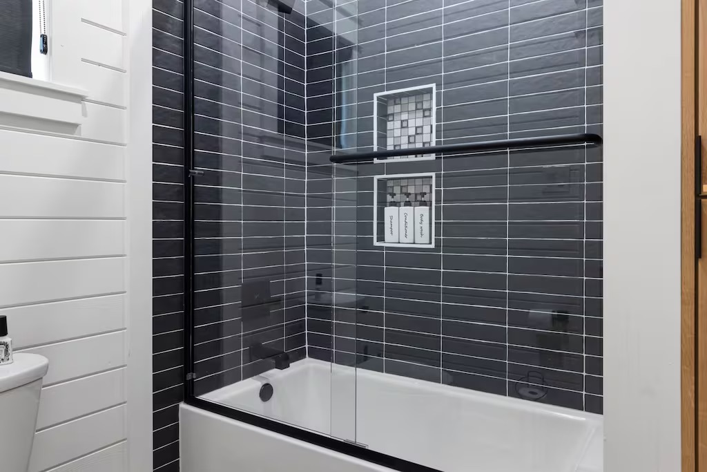 Spa-Inspired Bathroom: Experience luxury with sleek tile, modern fixtures, and a relaxing tub!