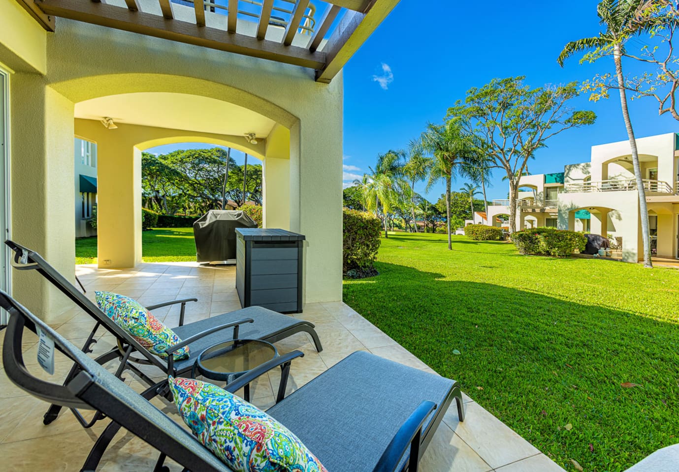 view from the chaise lounges onto a large lawn (behind you is the sliding door to the bedroom). Note the BBQ has been removed from all lanais in May 2024. There are now common BBQ areas around the property