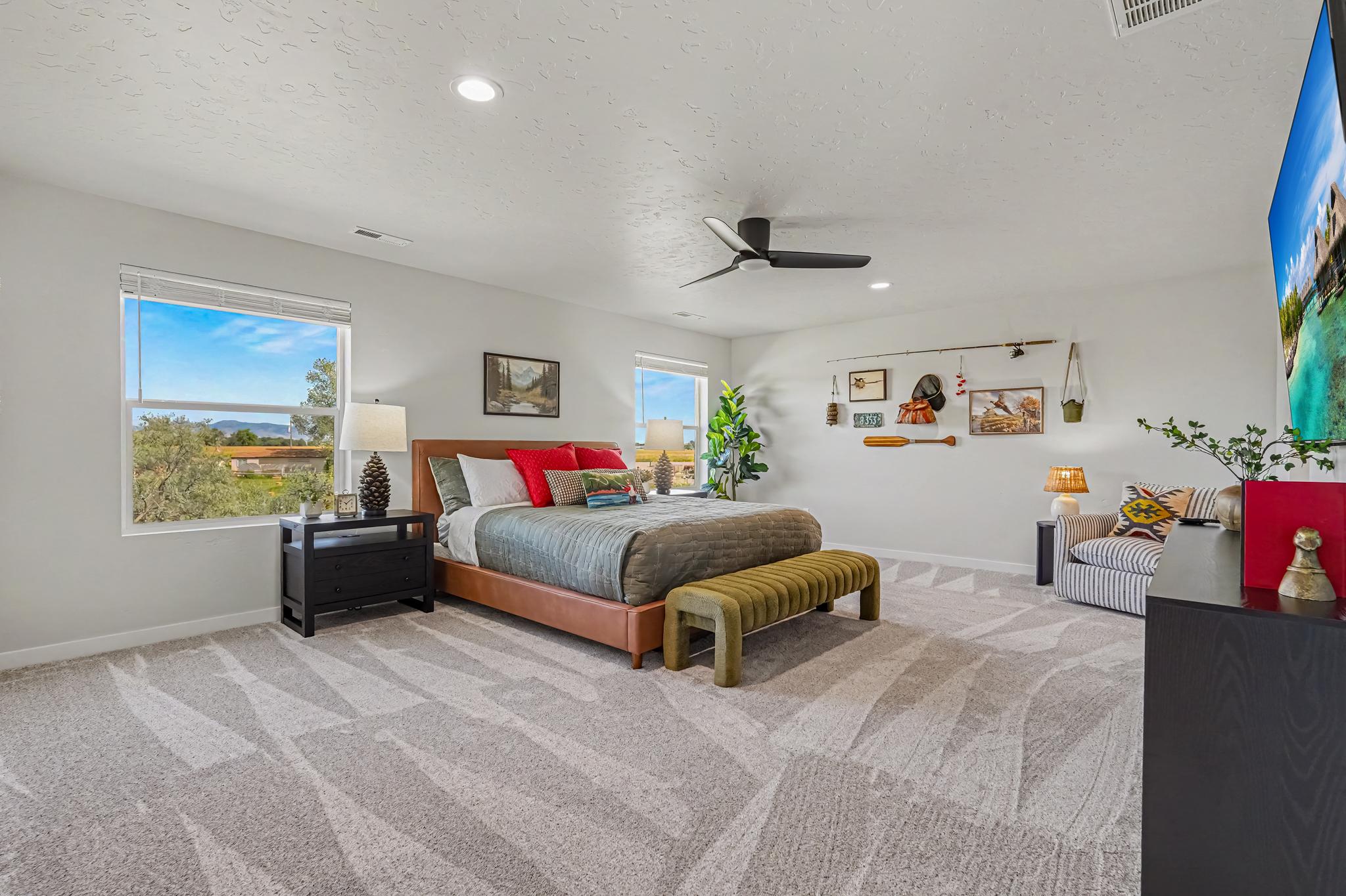 The luxurious master bedroom features a California king-size bed with a professionally designed setup that blends comfort and style. Enjoy relaxing in bed while watching your favorite shows on the 55-inch smart TV.