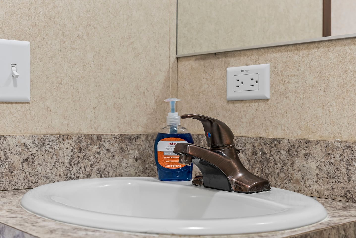 Bright vanity and mirror setup with ample space—perfect for your daily routine while staying in this cozy Airbnb.