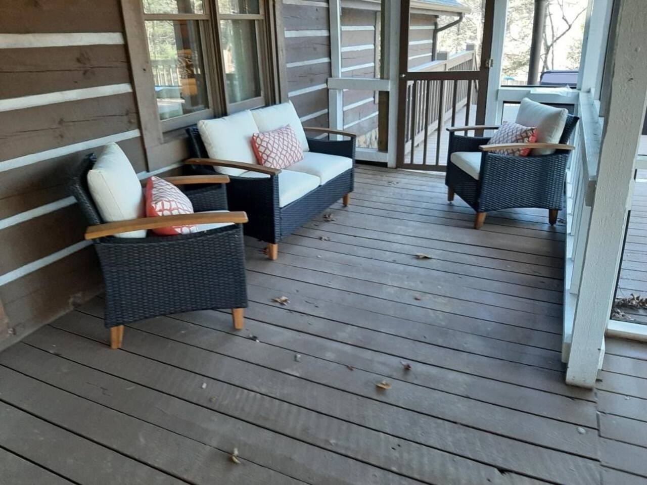 This is one of the outdoor seating areas that is covered and screened in.  This is part of the large cabin and joined to the deck with hot tub, grill, and fire pit.