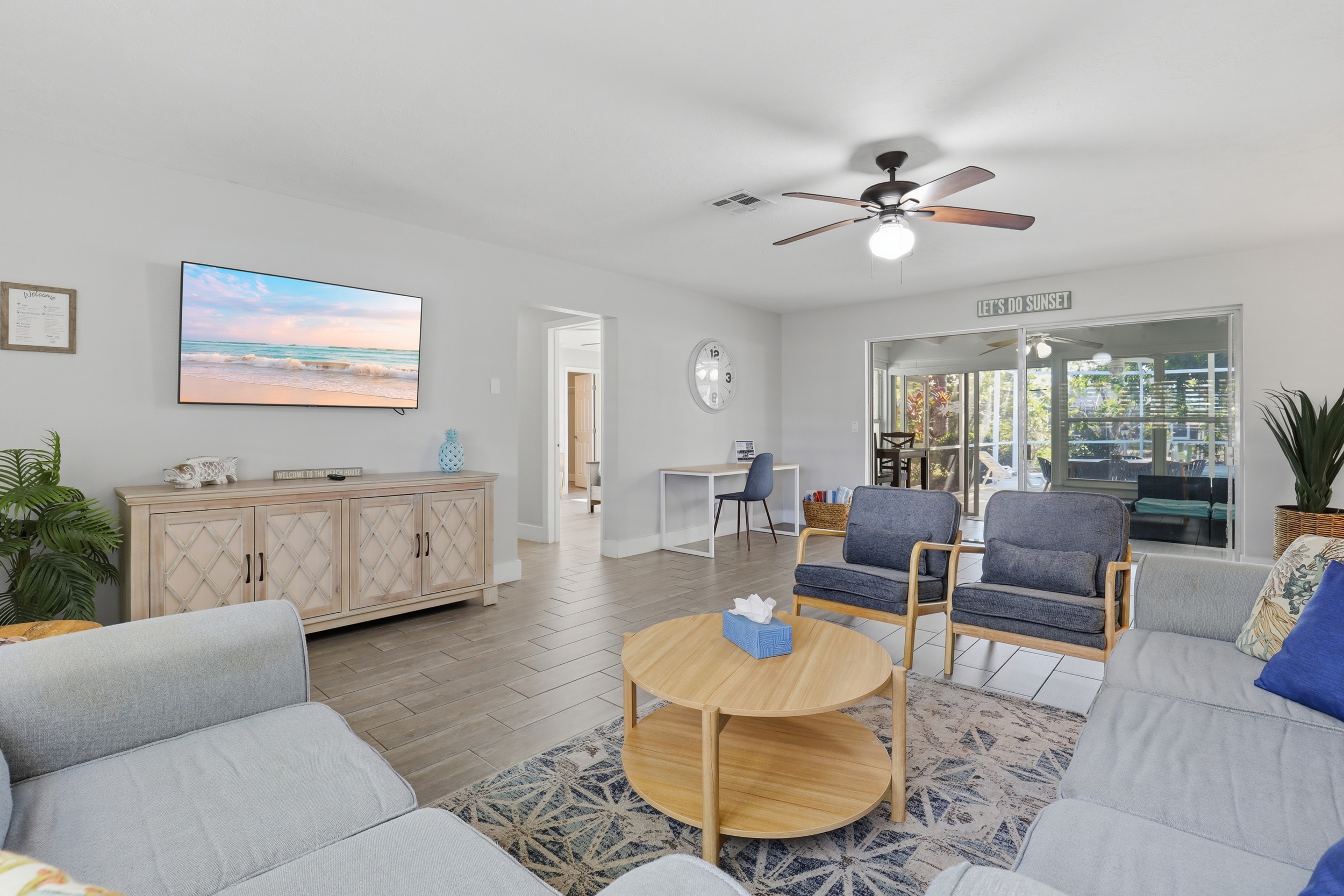 Open plan living room with TV and access to the lanai.