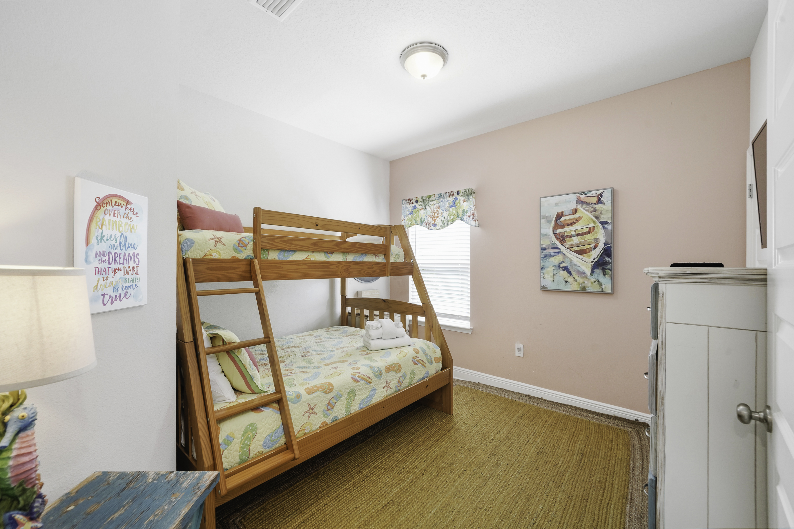 Bedroom 3: Twin-over-full bunk bed, Smart TV, dresser, and closet