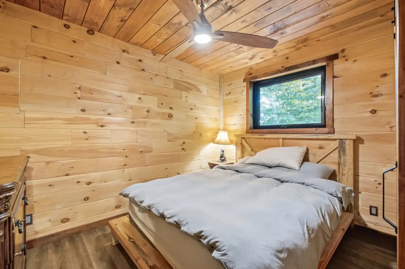 Cozy bedroom with warm wood-paneled walls
