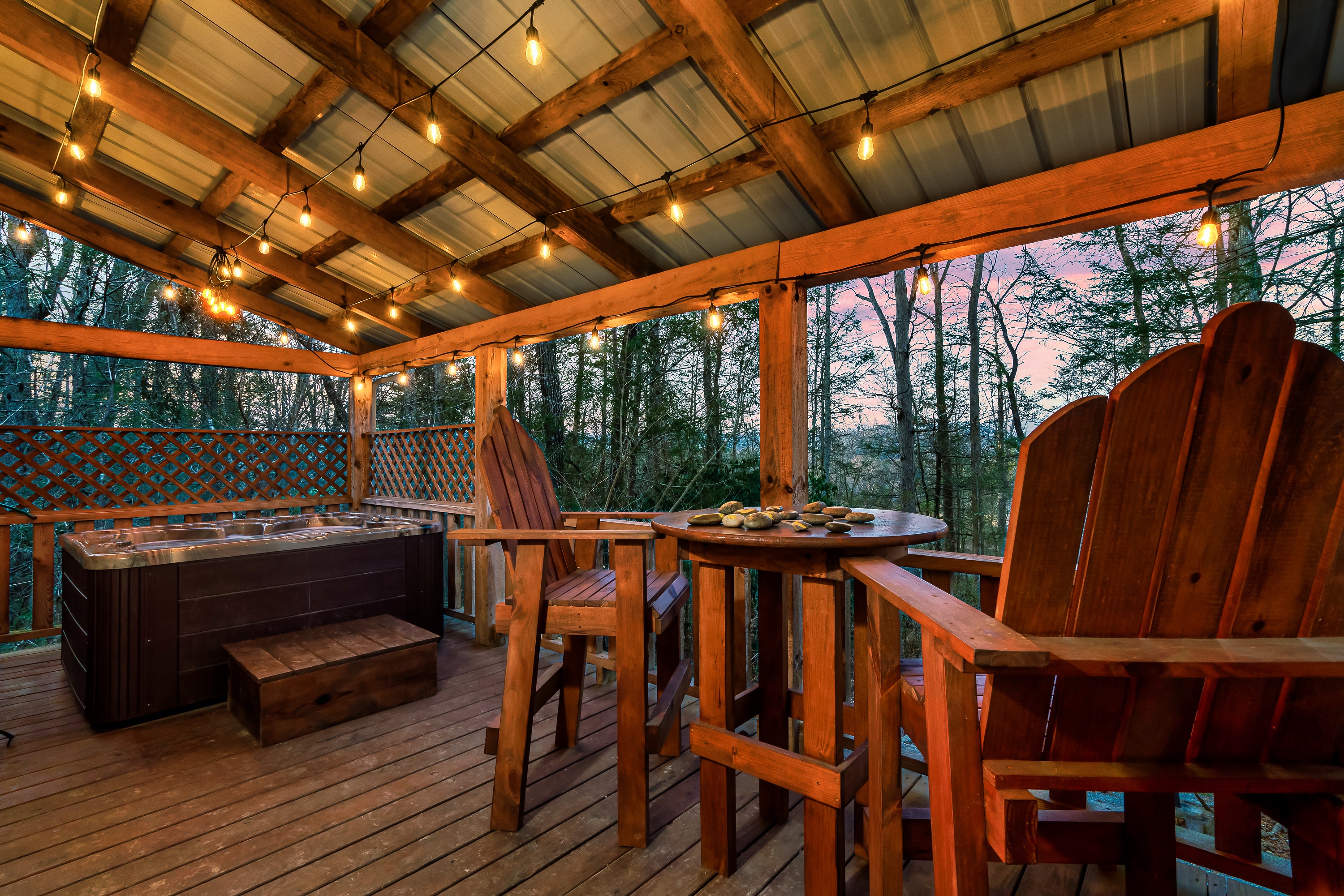 Covered deck with hot tub and forest views