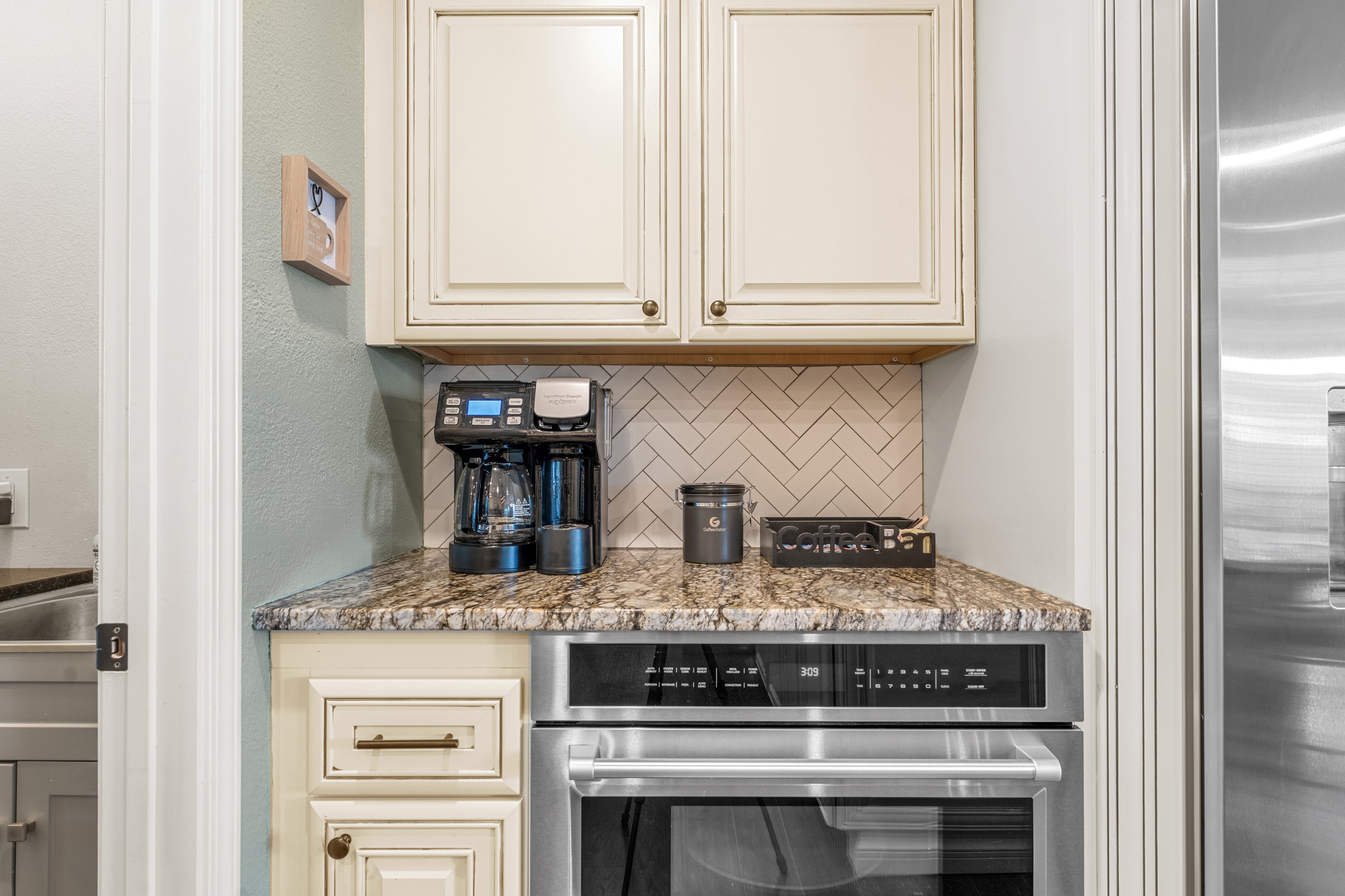 Coffee bar with drip and single-serve brewers above a wall oven. Mornings start right here, and that makes me happy.