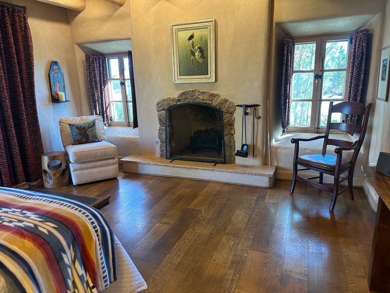 Electric fireplace log in fireplace, controlled by remote, also serves as a heater. 