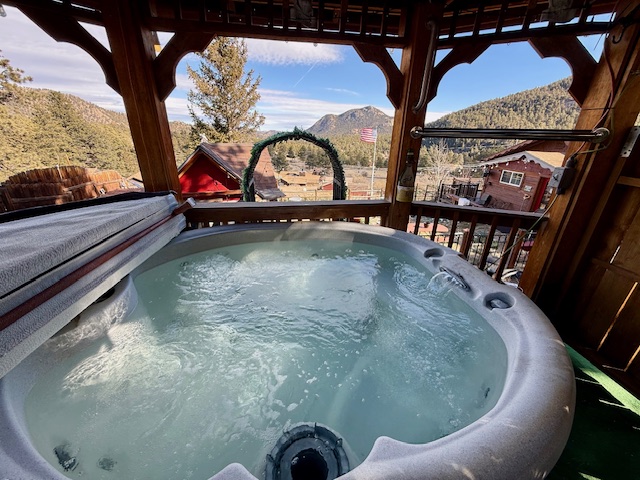 Soak under the covered gazebo with sweeping views of the valley and peaks.