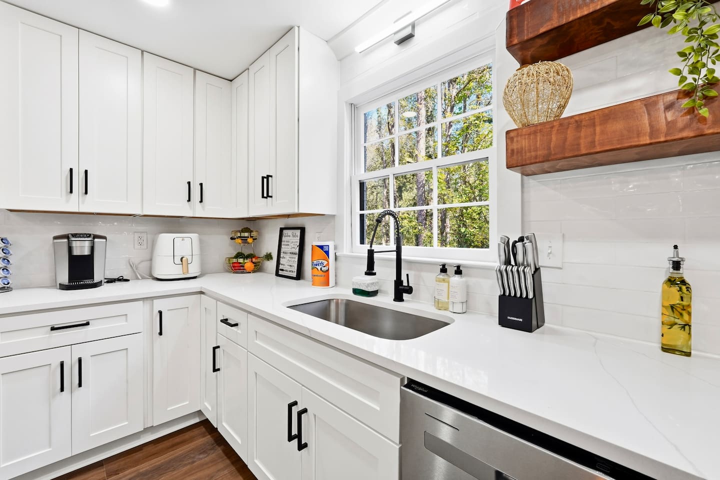 Beautiful white kitchen fully equipped with all the appliances and essentials of a home away from home.