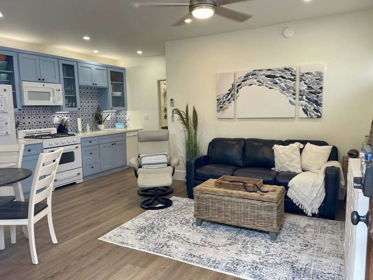 Good-sized living room with leather recliner and sofa bed. 