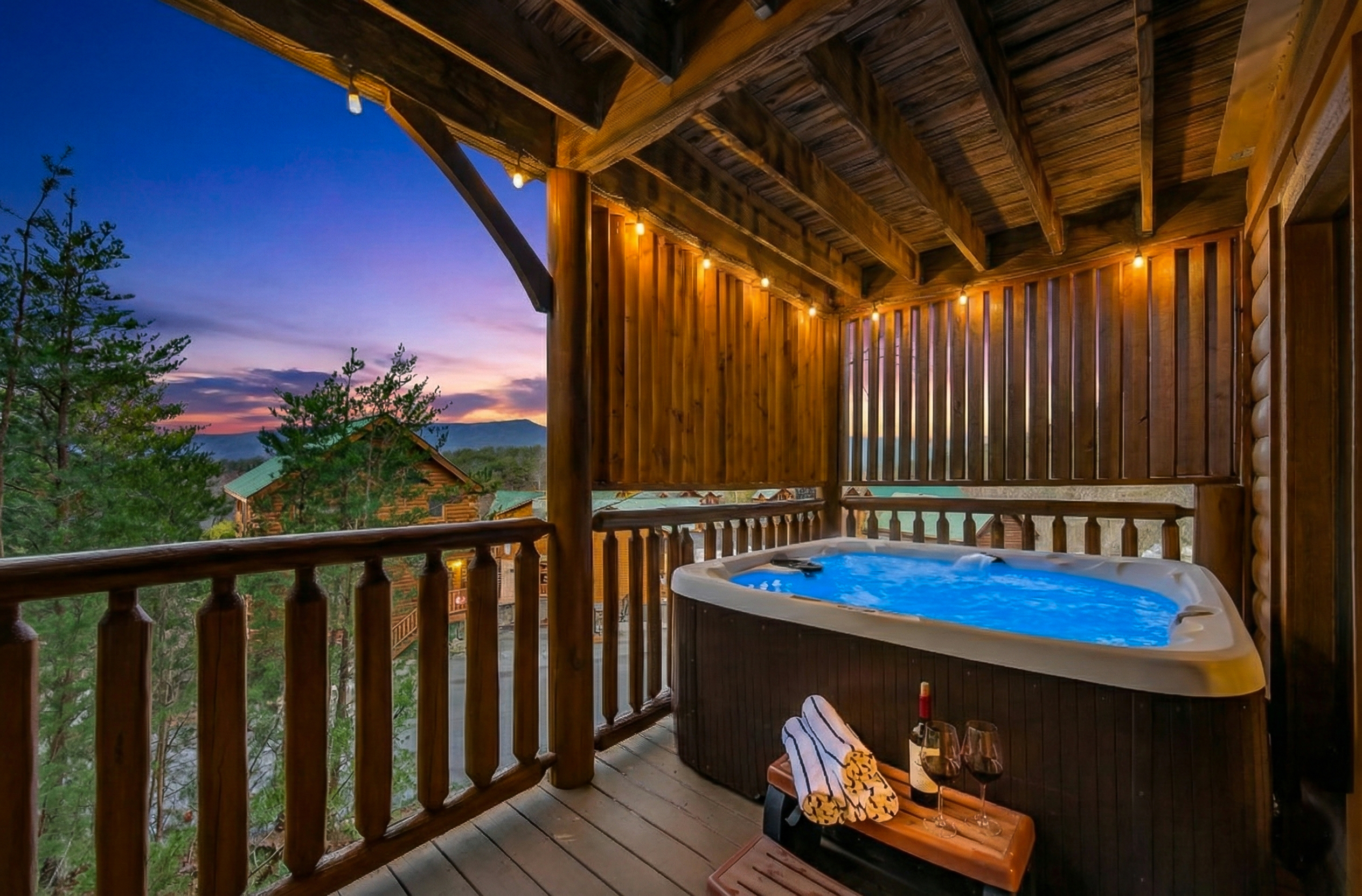 Your evening starts here — covered hot tub, Smoky Mountain sunset, and nowhere else you need to be. Pool towels provided for every guest.