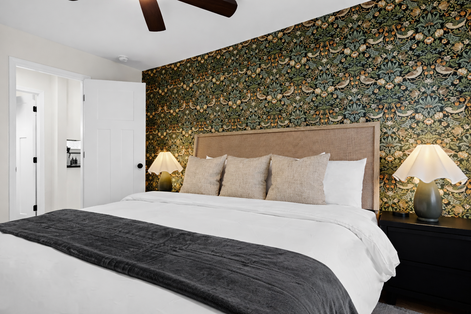 Rest easy in this stylish bedroom with a plush bed, warm lighting, and bold accent wall—designed for comfort, relaxation, and great sleep.