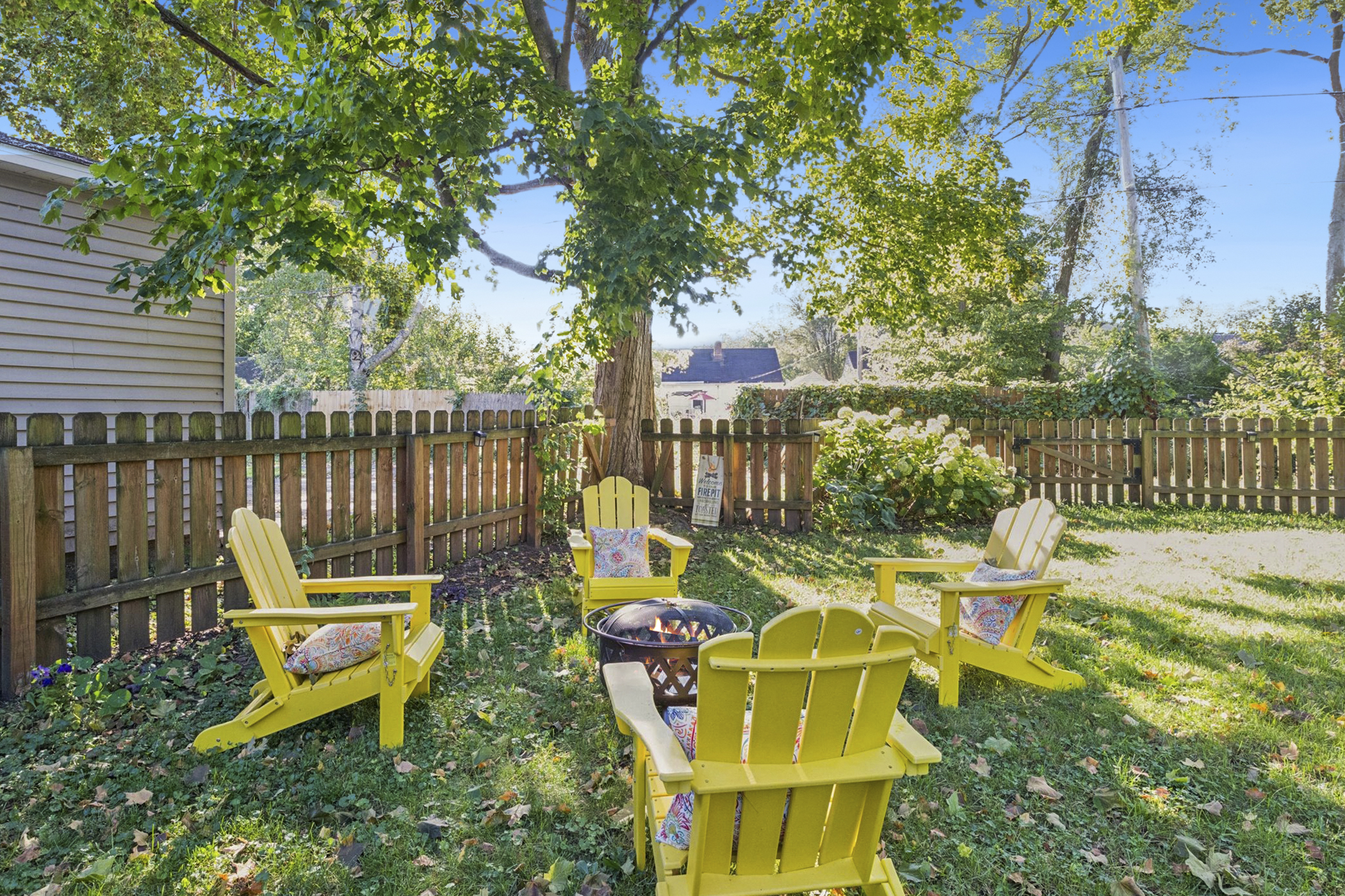 Gather, unwind, repeat—our South Bend retreat features Adirondack chairs and a wood-burning firepit, perfect for family-friendly evenings near Notre Dame. S’mores await.