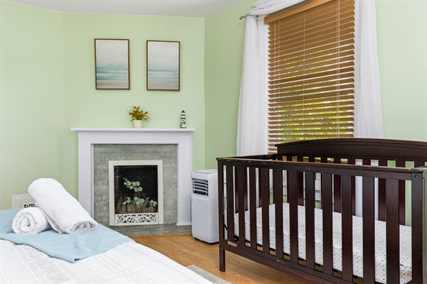 Spacious, cozy bedroom with a fireplace. Stretch out in the queen-sized bed while your little sleeps soundly in the crib.