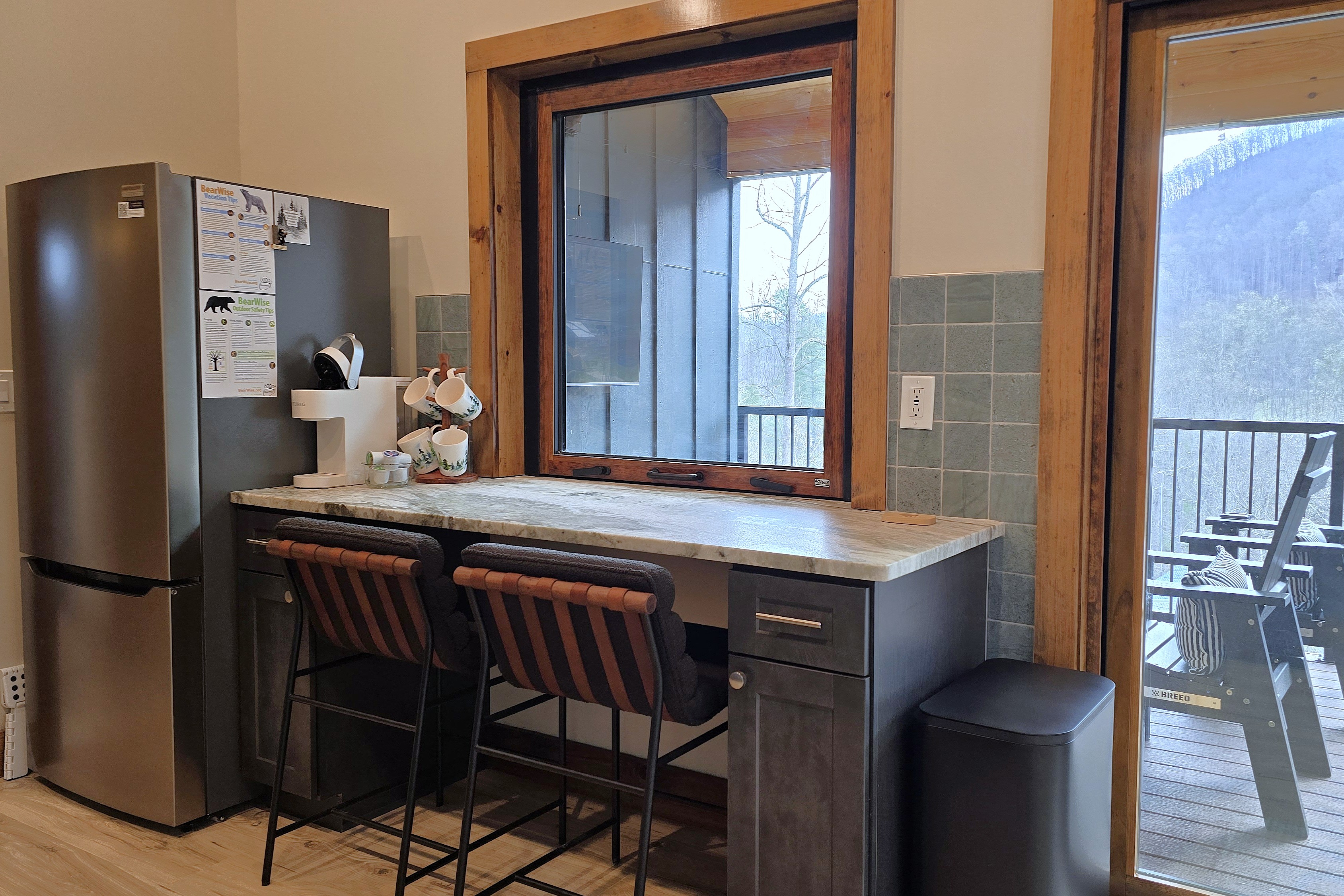 Two-person seating at the bar with flip up window to the deck