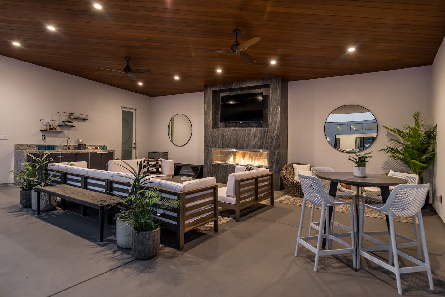 Outdoor covered lounge - with fireplace, TV, bistro table, couch, bathroom, wet bar, papasans and spa access